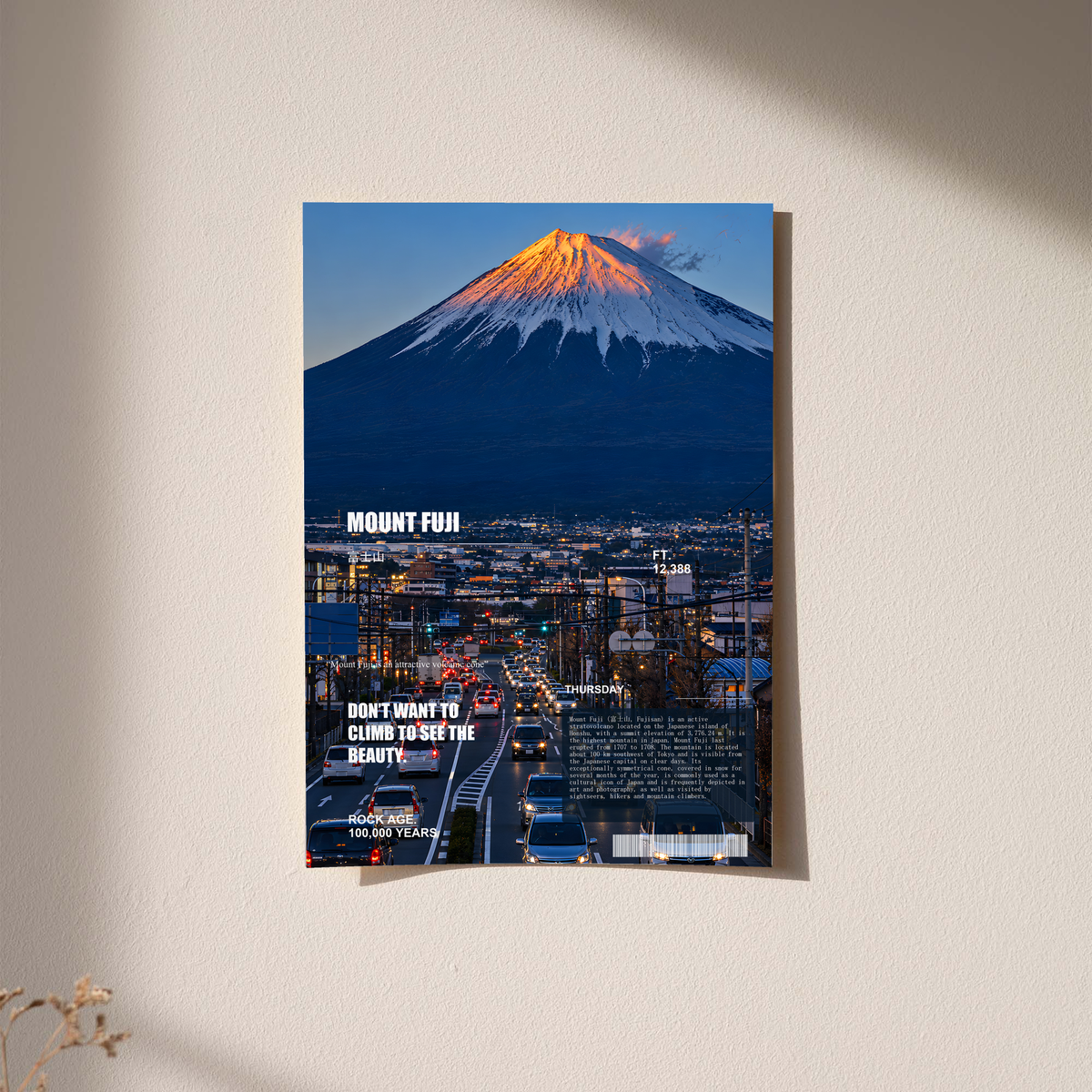 Orange-lit Mount Fuji above a deep blue city in an editorial collage; unframed print on a wall