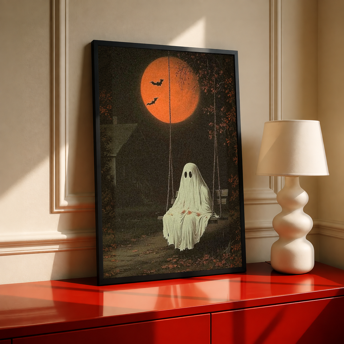 Framed ghost swing art print with orange moon, flying bats, and a pale ghost figure