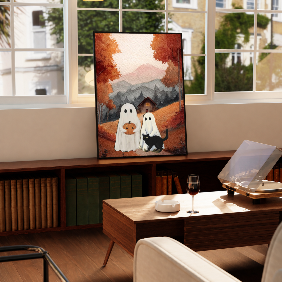 Black-framed ghost and black cat art print featuring pumpkin in autumn mountain landscape