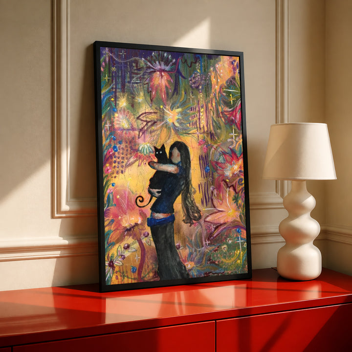 A girl embracing a black cat amid colorful ornamental flowers and patterns in a black frame on a red console beside a sculptural cream lamp