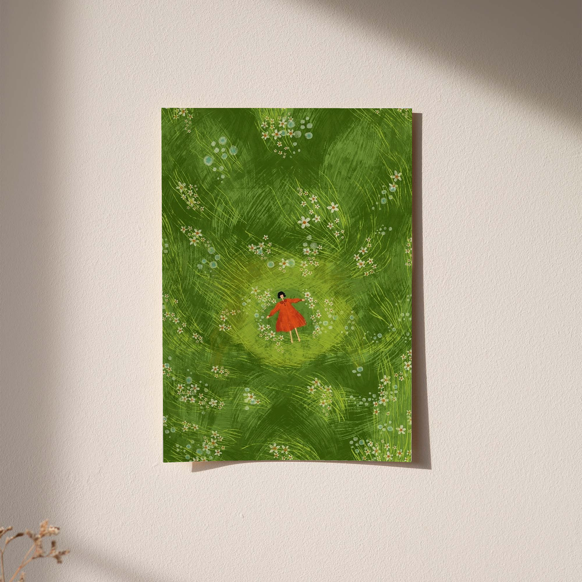Girl in red dress in a green flower meadow as an unframed print against a pale plaster wall with soft shadows