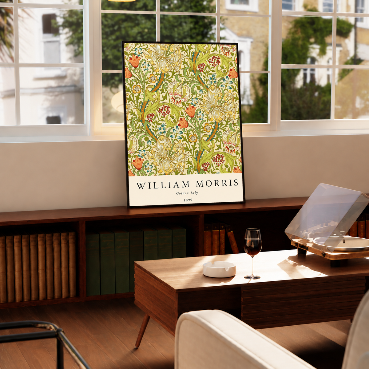 Golden Lily floral pattern with olive leaves, yellow flowers and red accents in a black frame on a cabinet beside a window and record player