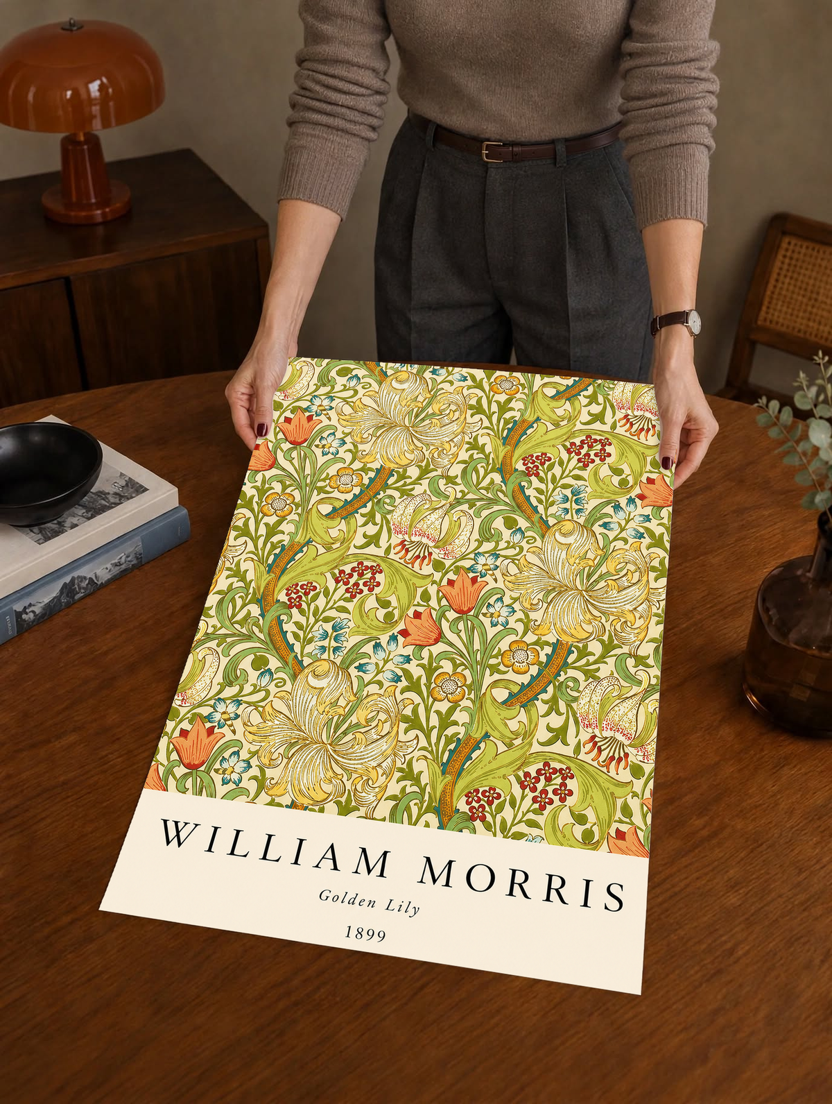 Golden Lily floral pattern with olive leaves, yellow flowers and red accents as an unframed print held over a wooden table beside a record player