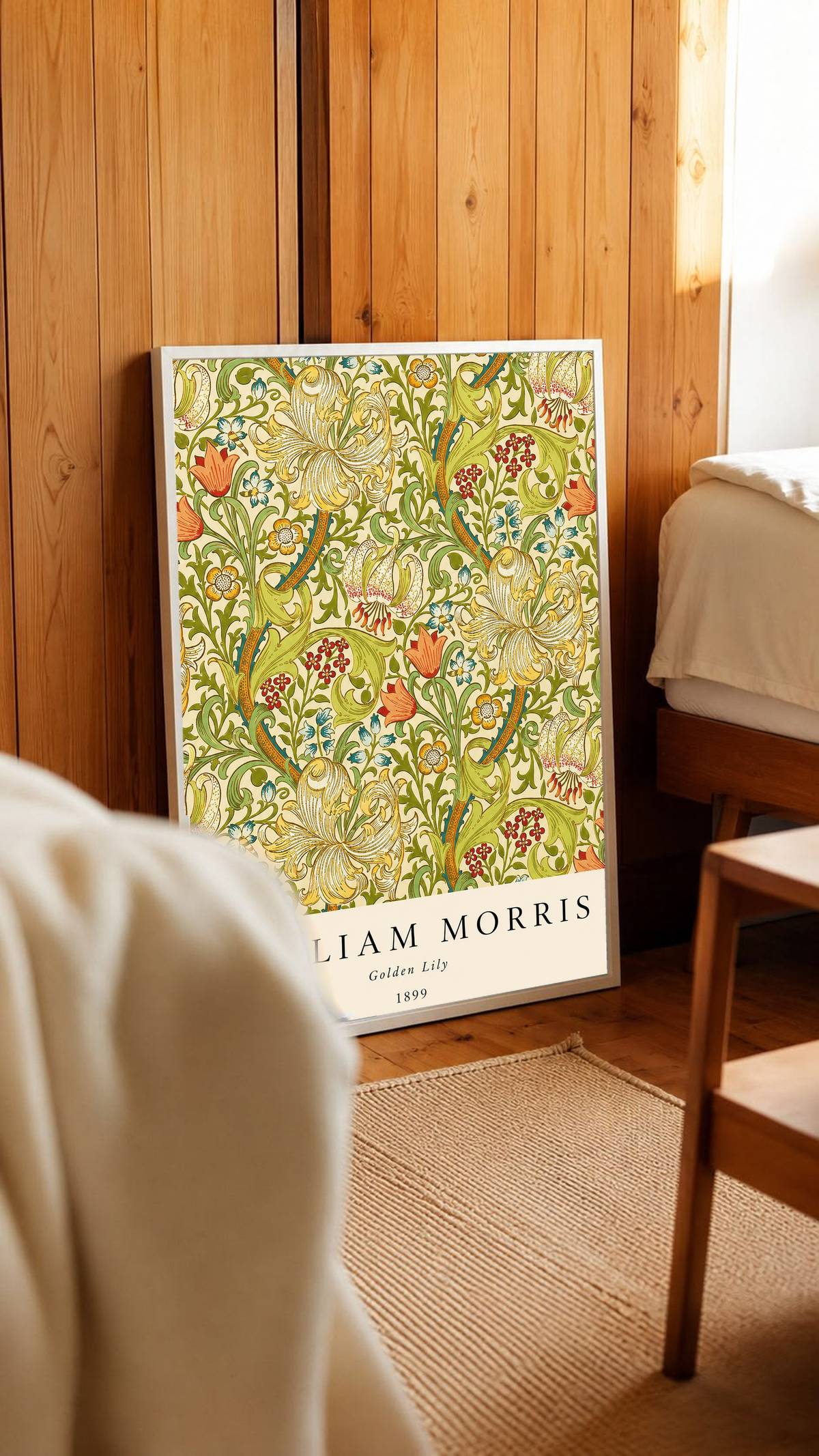 Golden Lily floral pattern with olive leaves, yellow flowers and red accents in a white frame in a wood-panelled bedroom