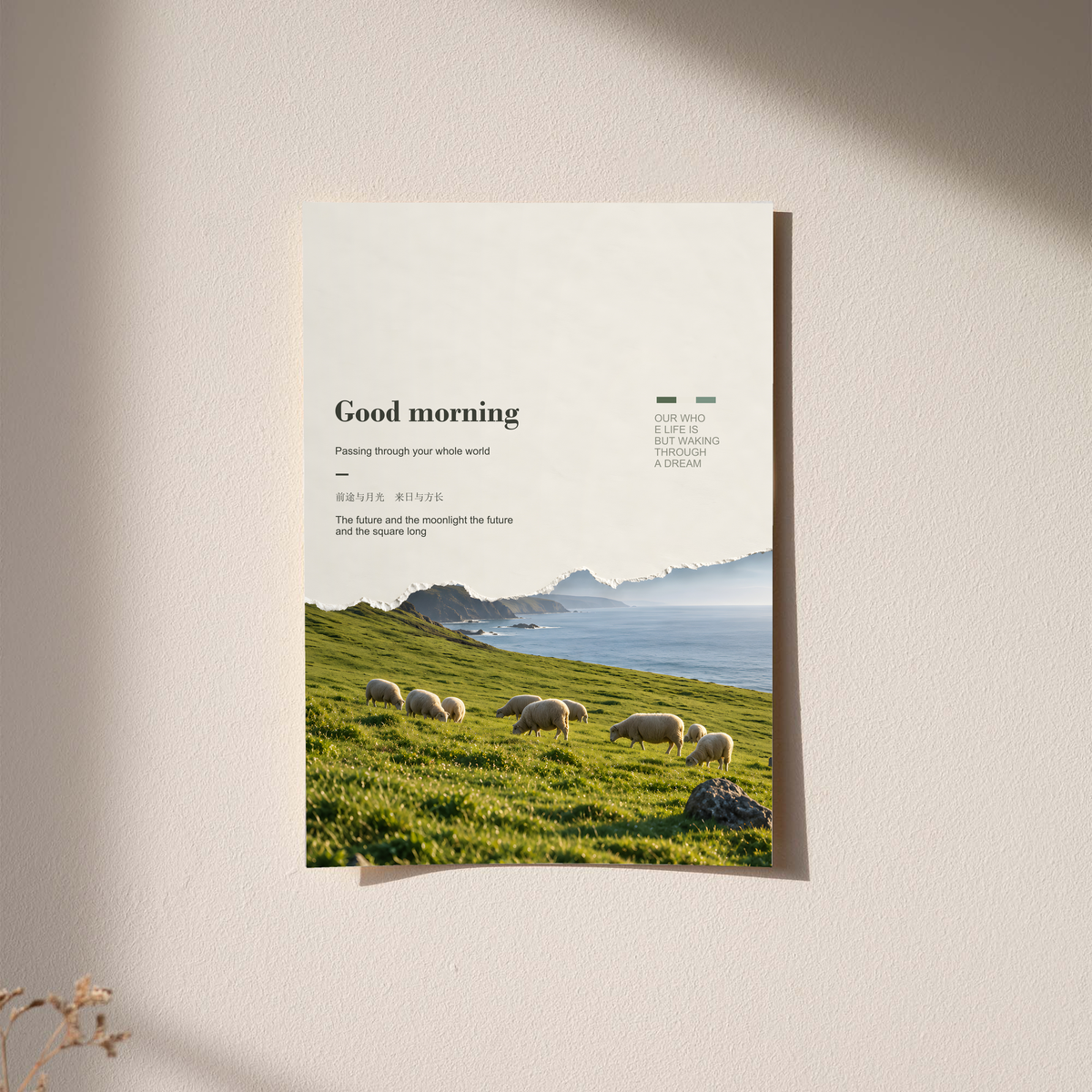 White sheep in a green pasture with misty cliffs and Good Morning lettering; unframed print on a wall