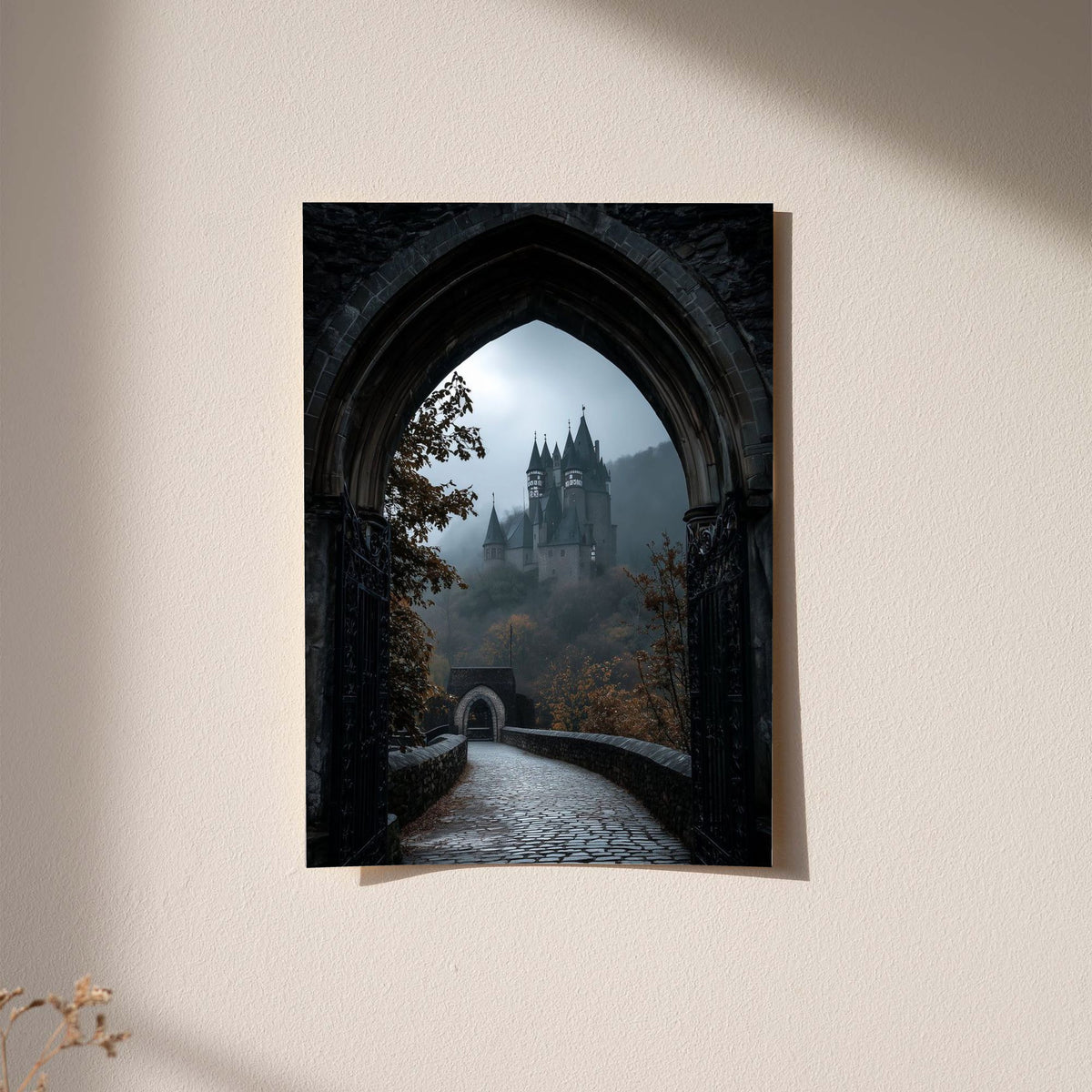 A distant gothic castle seen through a pointed stone arch above a cobbled path displayed without a visible frame on a softly lit pale wall