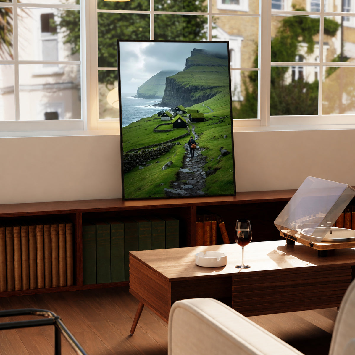 Framed landscape wall art with green hills, seaside cliffs, and a hiker on a stone path