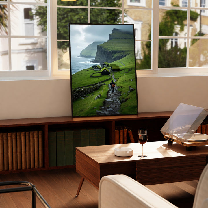 Framed landscape wall art with green hills, seaside cliffs, and a hiker on a stone path
