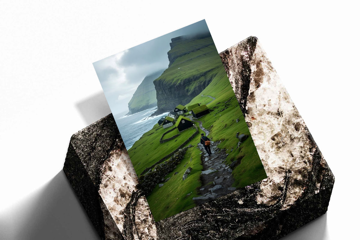 Landscape print with green cliffs, seaside village houses, and a hiker on a rocky path