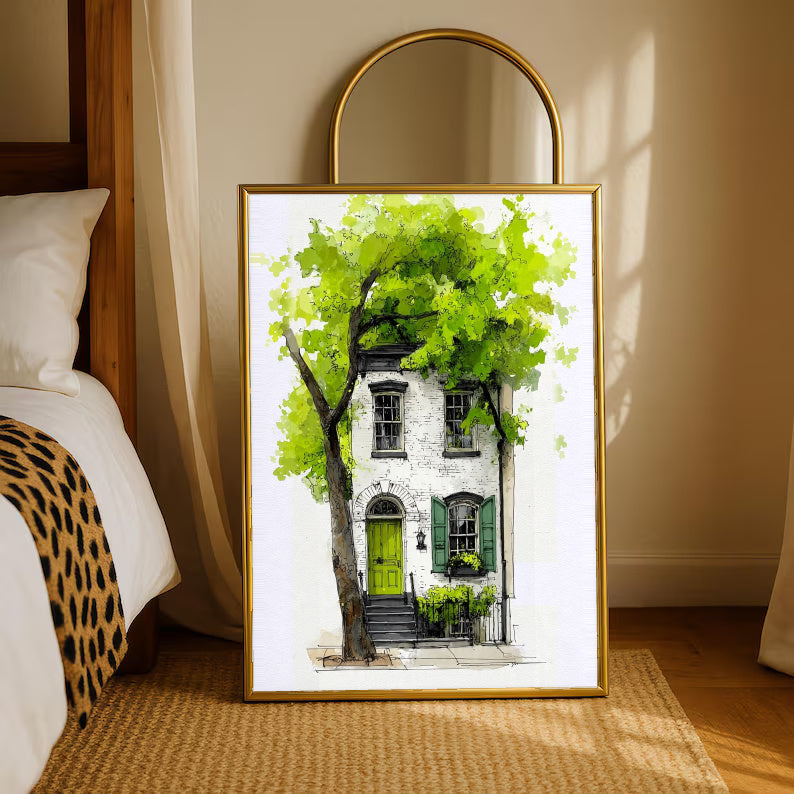 Gold-framed watercolor townhouse print with leafy tree and bright green door