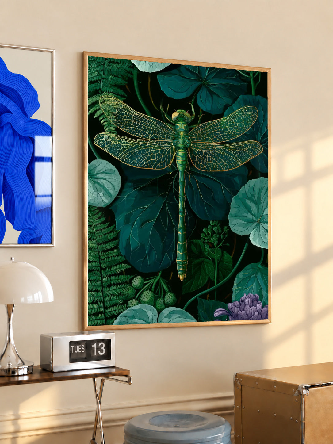 Framed botanical wall art with green dragonfly and gold wing detail over leafy foliage