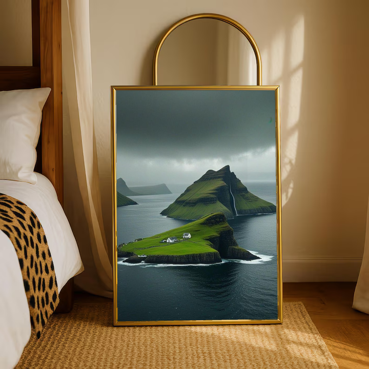 Green island cliffs and dark sea in a warm wood frame on a bedroom floor beneath an arched mirror
