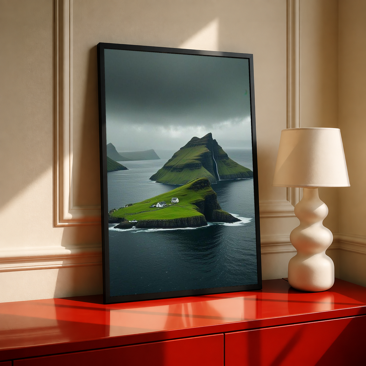 Black-framed landscape print of green cliffs, dark sea, and storm clouds