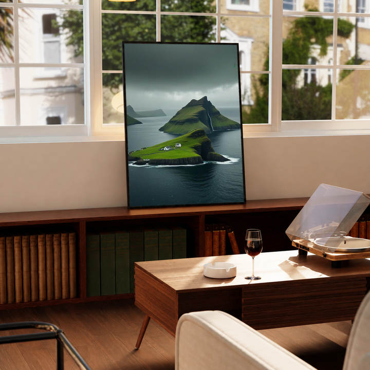 Green island cliffs and dark sea in a black frame on a windowsill above a green radiator, with a turntable nearby