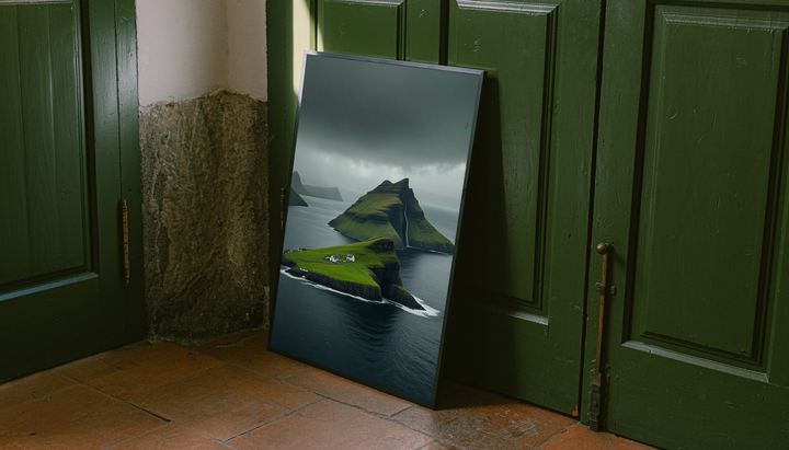 Green island cliffs and dark sea as an unframed display leaning against a green paneled door on a wood floor