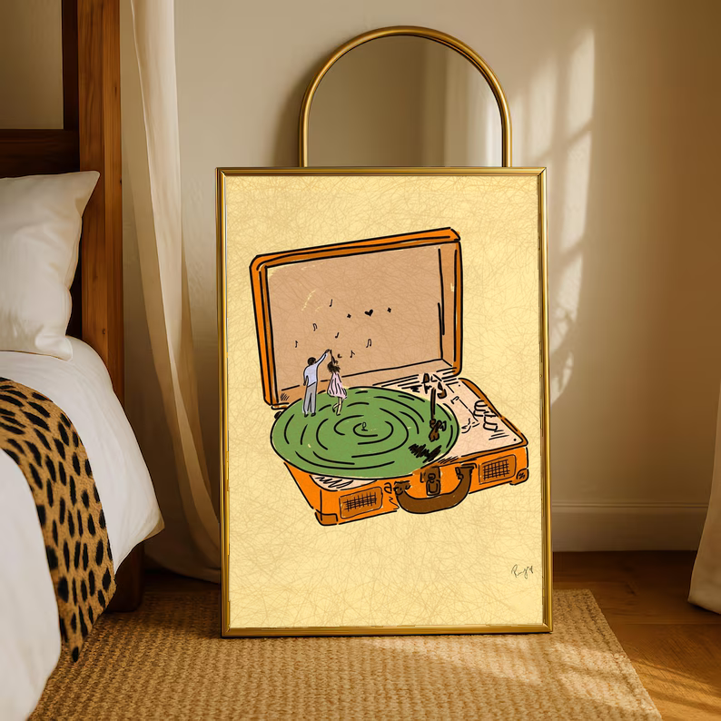 Gold-framed record player art print with green turntable and tiny dancer figures on rug