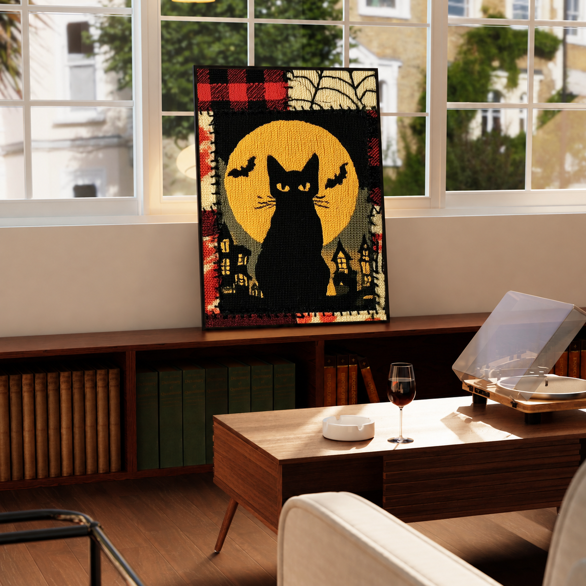 Halloween black cat and yellow moon in a black frame on a windowsill above a green radiator, with a turntable nearby