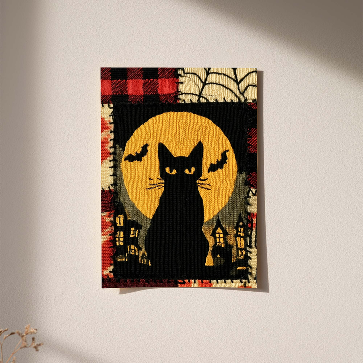 Halloween black cat and yellow moon as an unframed print against a pale plaster wall with soft shadows