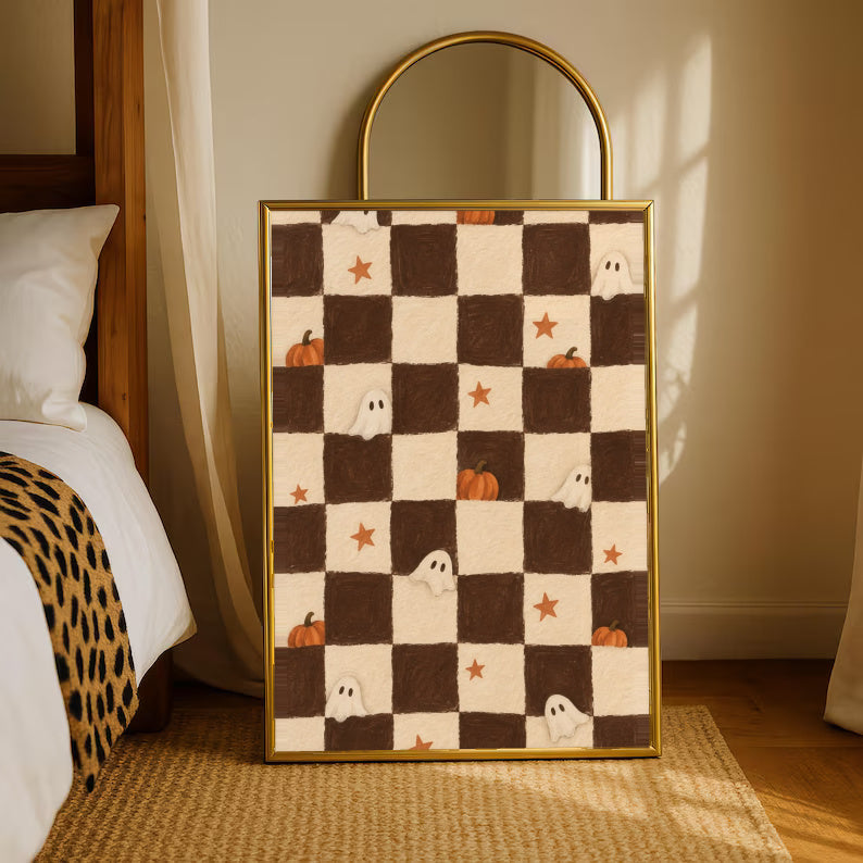 Brown and cream Halloween checkerboard with little white ghosts, pumpkins and orange stars in a gold-tone styling frame leaning beside a bedroom mirror