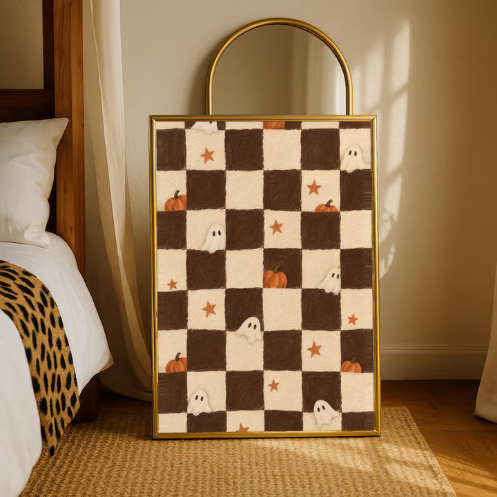 Brown and cream Halloween checkerboard with little white ghosts, pumpkins and orange stars in a gold-tone styling frame leaning beside a bedroom mirror