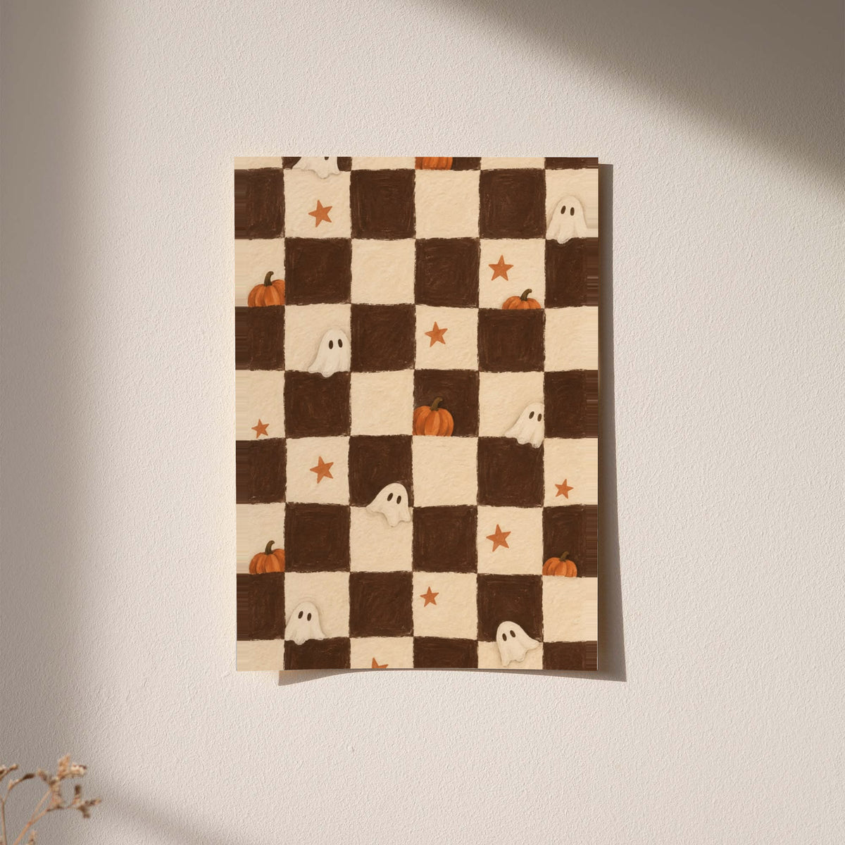 Brown and cream Halloween checkerboard with little white ghosts, pumpkins and orange stars displayed without a visible frame on a softly lit pale wall
