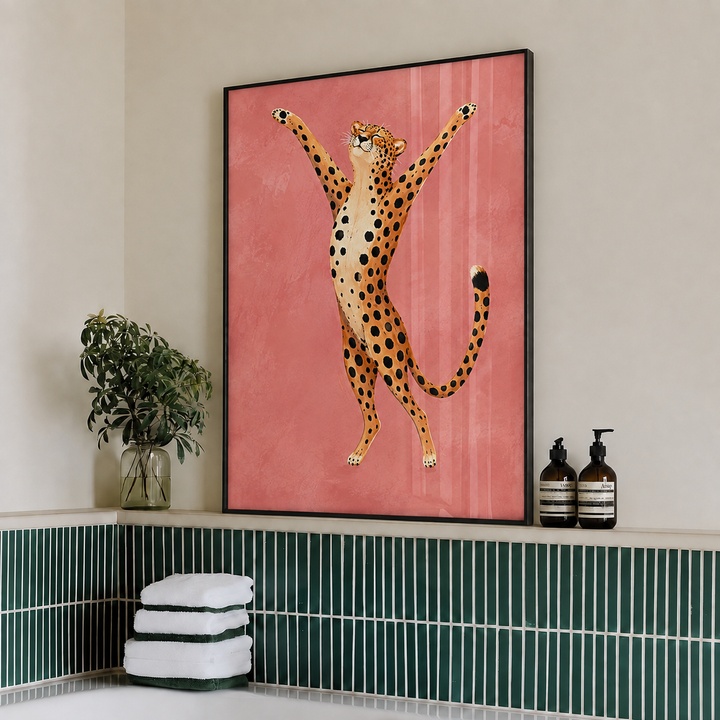 Framed cheetah wall art print on pink backdrop, black frame, standing cheetah pose