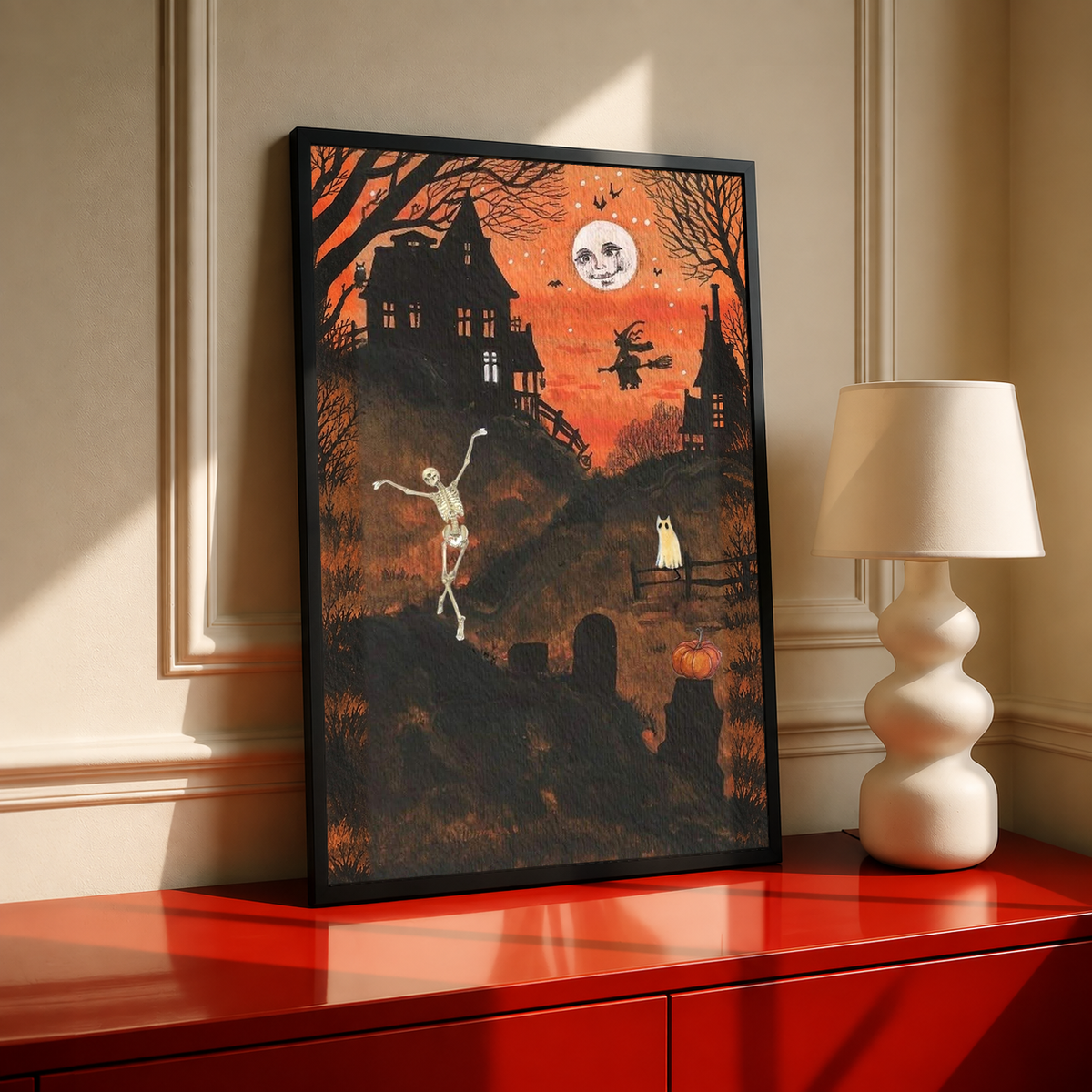 Halloween art print with dancing skeleton and moon face, in black frame