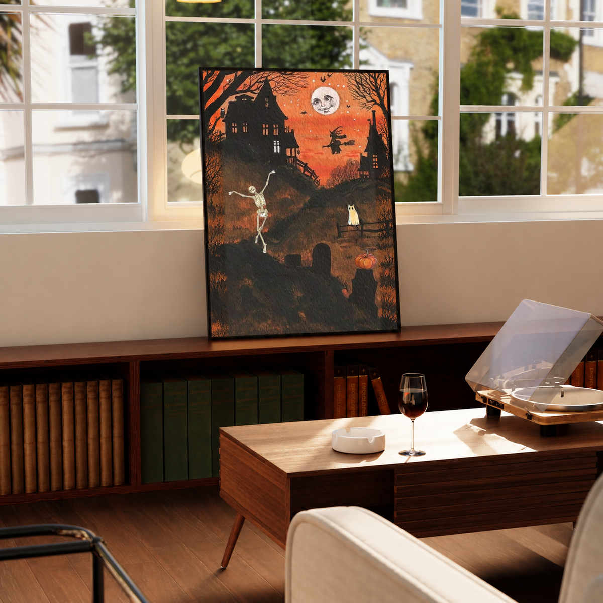 Halloween art print with dancing skeleton and moon face, black frame