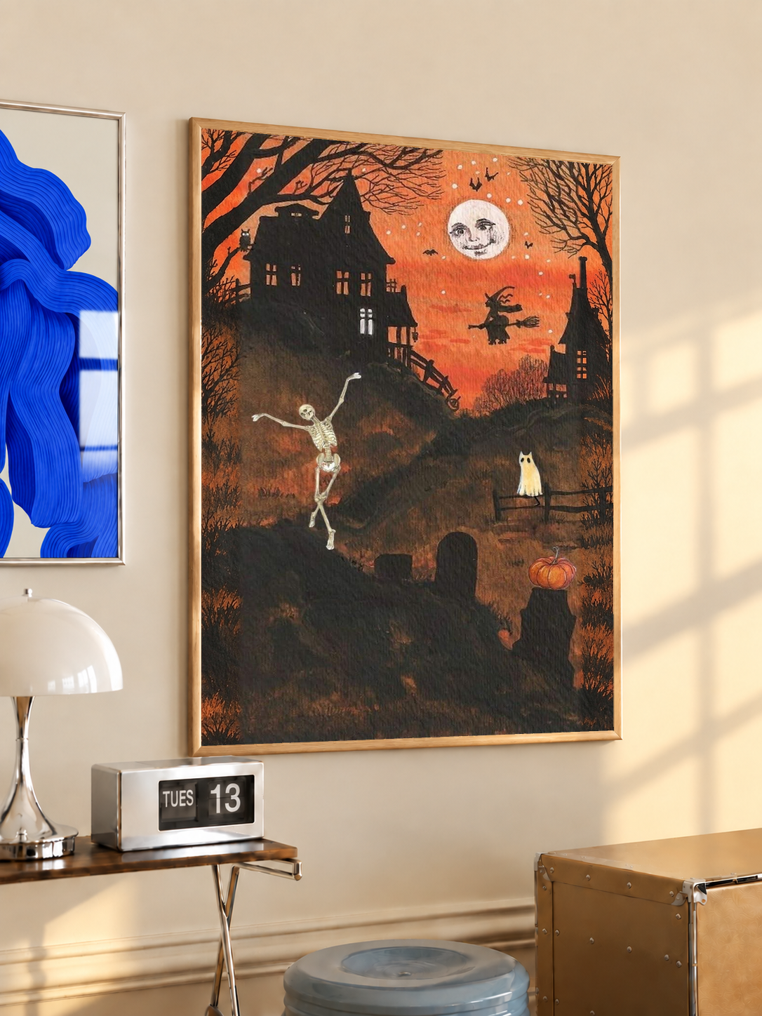 Halloween art print with dancing skeleton and moon face, black frame