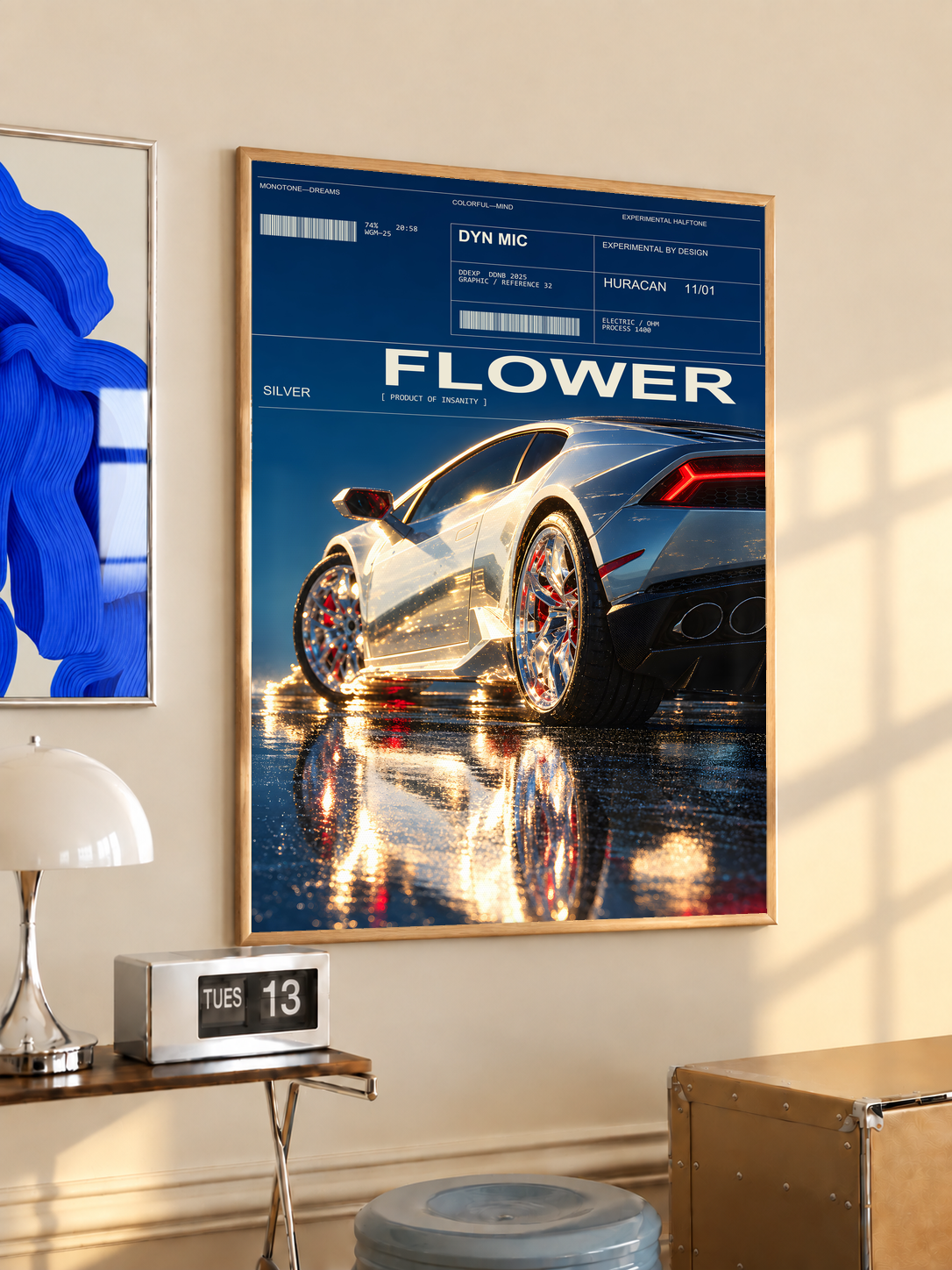 Silver Huracan with flowers around the rear wheel and night reflections; oak framed print in a desk setting
