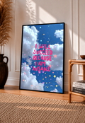 Framed inspirational poster with blue clouds, stars, and pink quote text