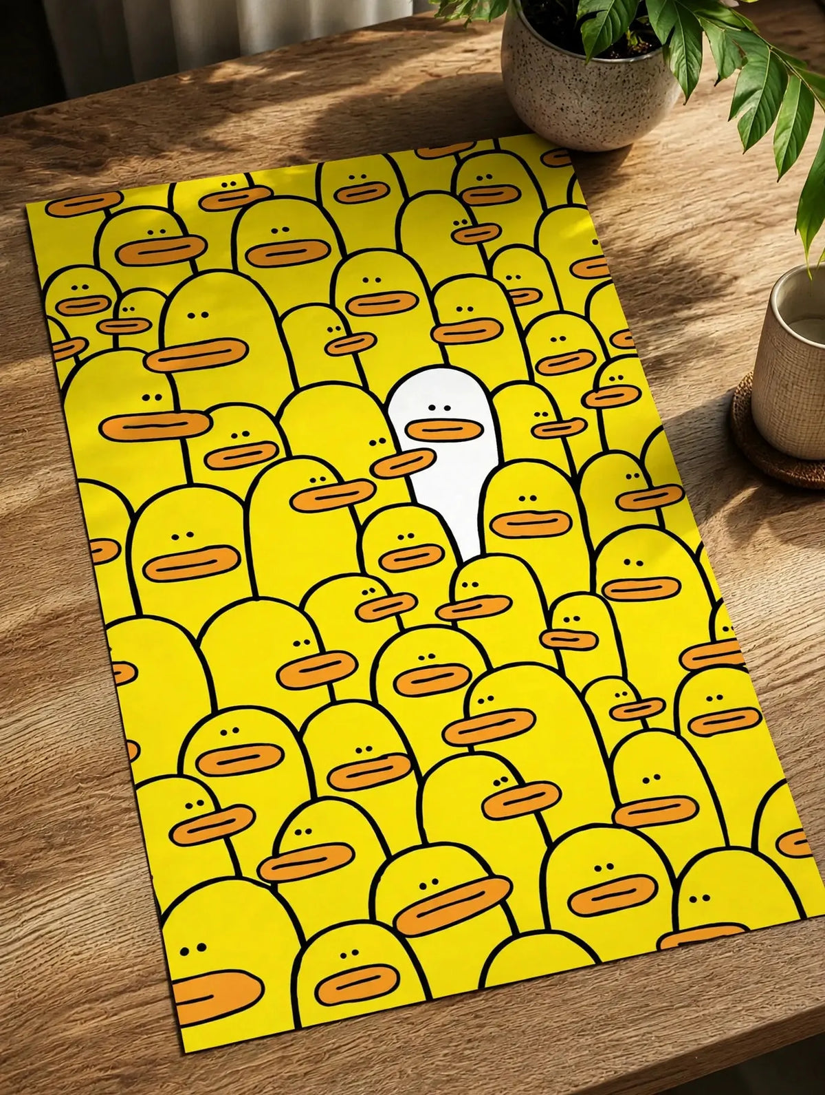 Yellow character-face pattern poster print laid on a tabletop.