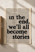Typographic art print on beige paper with large quote: “In the end we'll all become stories”