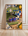 Framed green espresso machine poster with blue cups, a pressure gauge, lemons and kitchen props