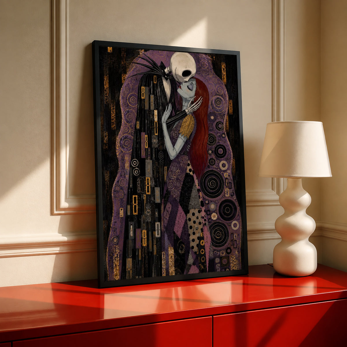Jack Skellington and Sally embracing amid purple, black and gold ornamental patterns in a black frame on a red console beside a sculptural cream lamp