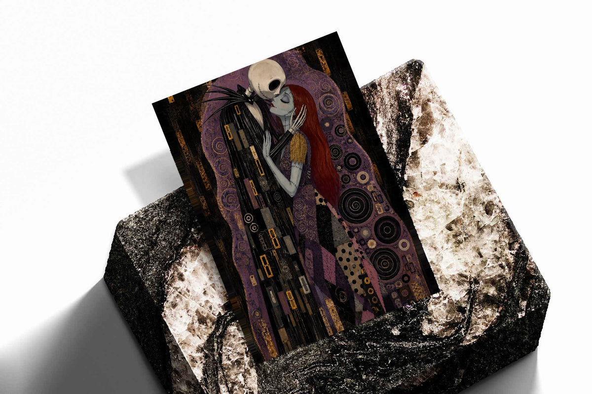 Jack Skellington and Sally embracing amid purple, black and gold ornamental patterns as an unframed print resting at an angle on a dark stone display