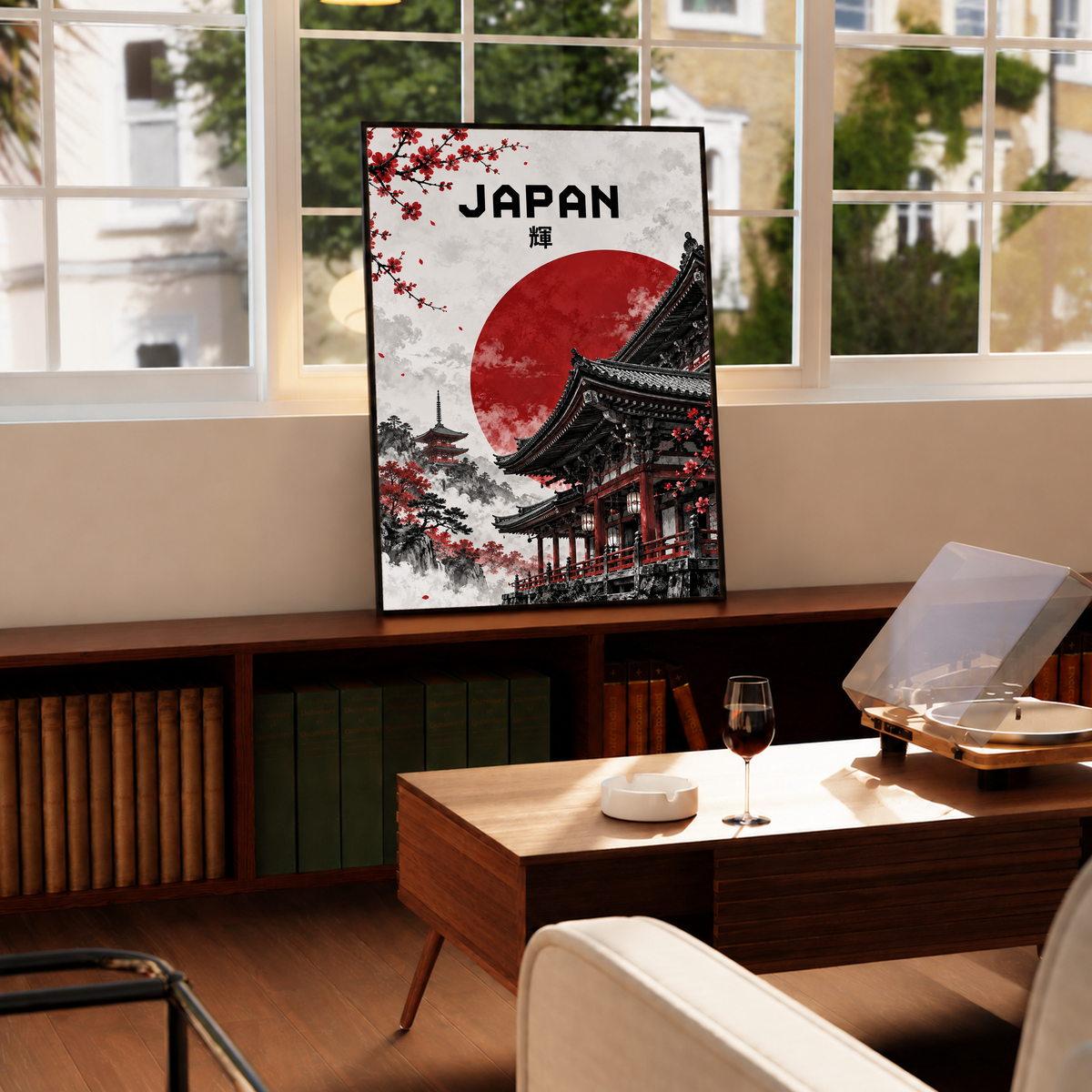 Framed temple poster by window with red sun, black temple rooftops, and cherry blossoms.