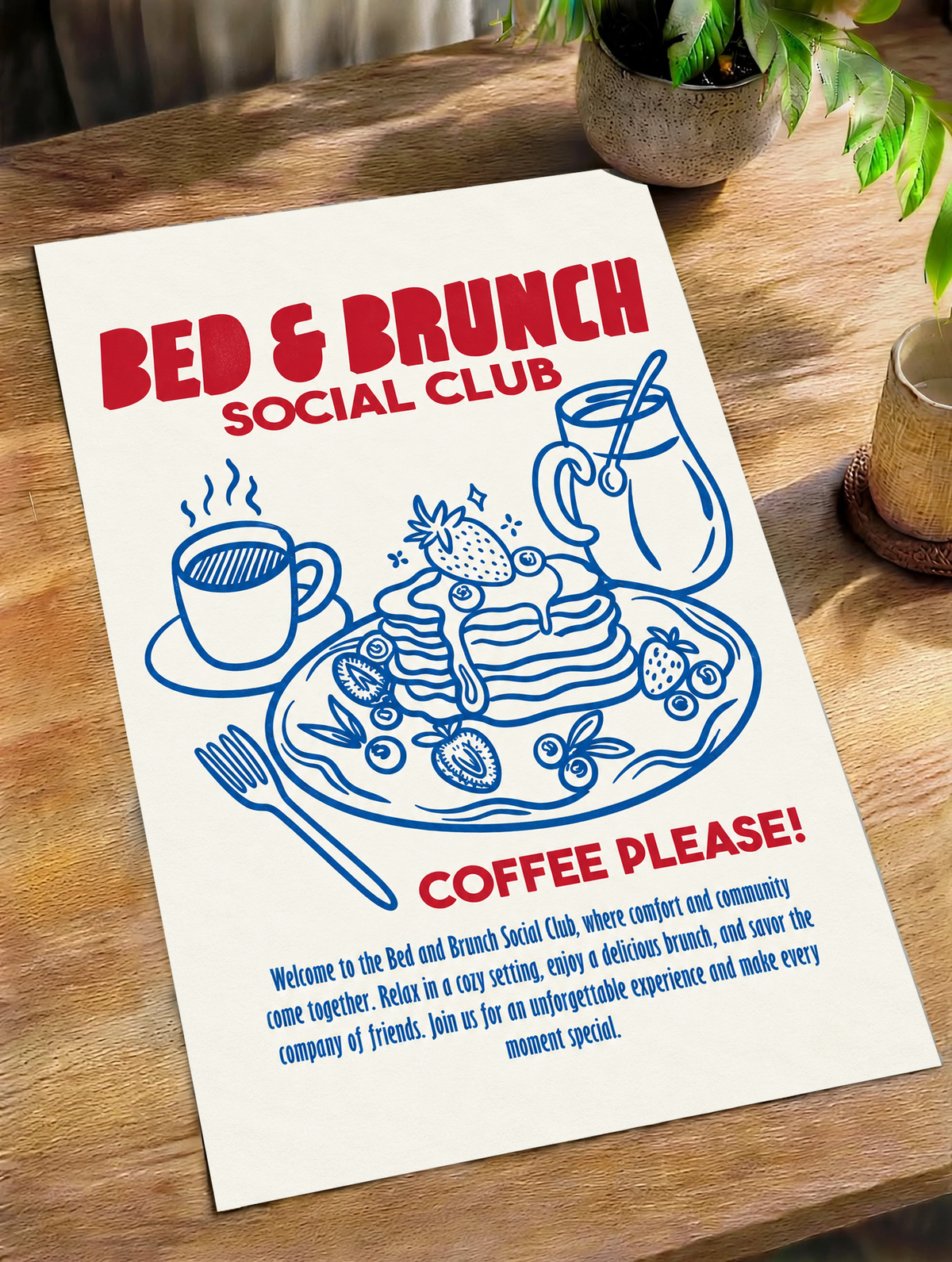 Bed & Brunch Social Club art print on wood table with red headline and blue coffee illustration.