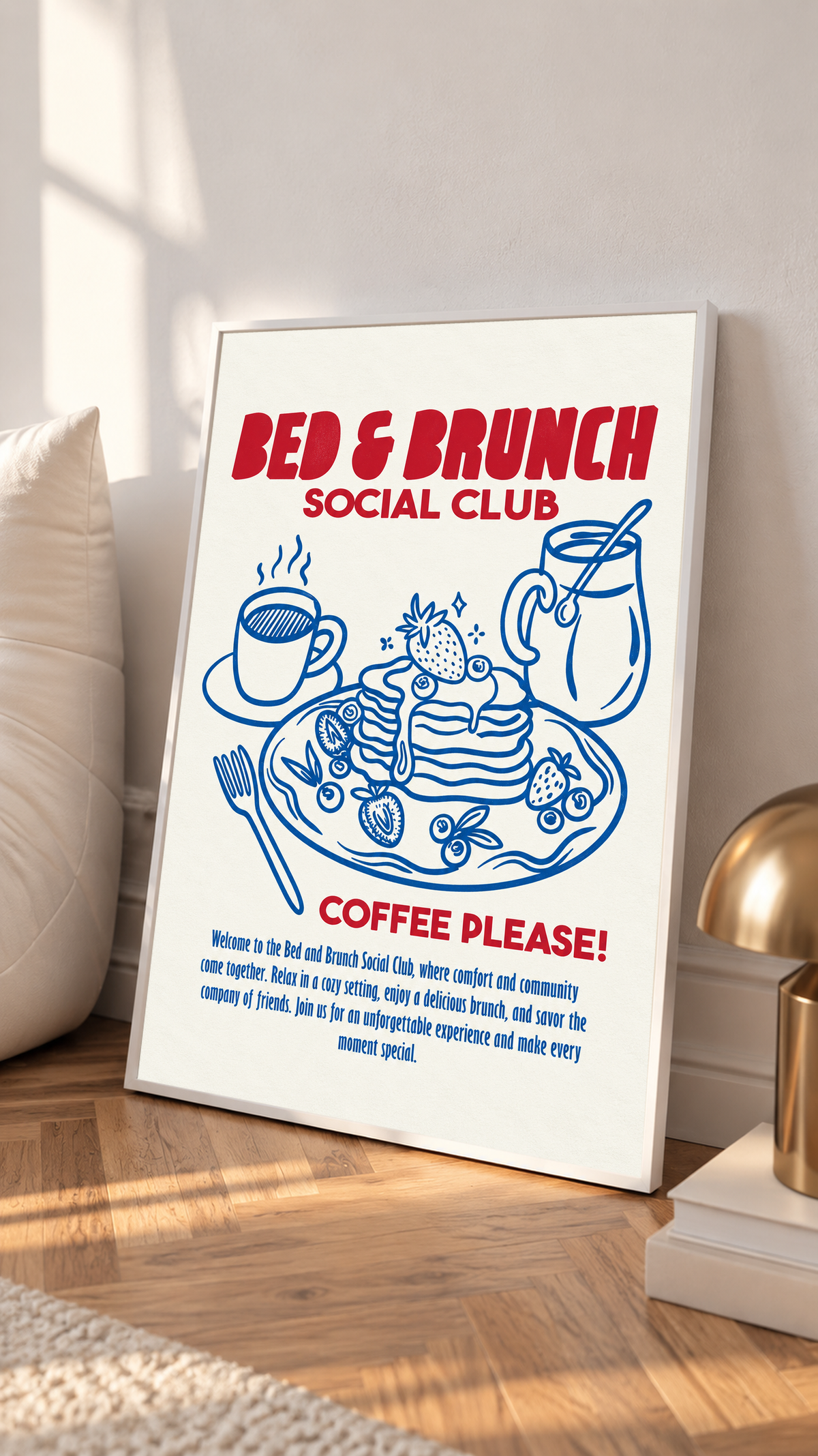 Framed Bed & Brunch Social Club art print on tabletop with blue pancakes and red headline.