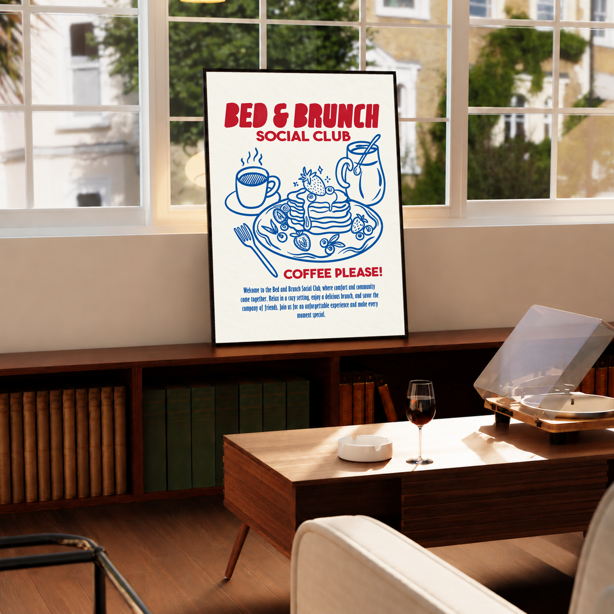 Framed Bed & Brunch Social Club art print on a console with red and blue coffee-pancake design.
