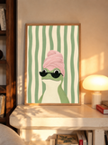 Frog art print in an oak frame, featuring a pink towel turban and black sunglasses
