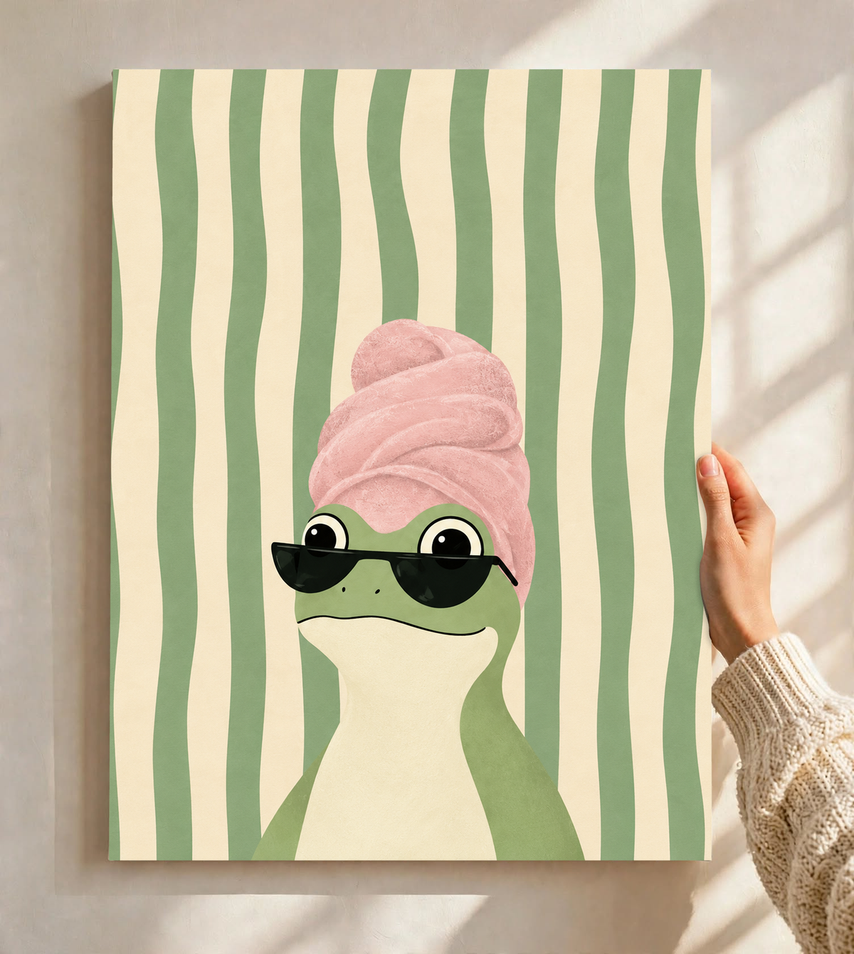 Stretched canvas frog art with a pink towel turban and black sunglasses on green stripes
