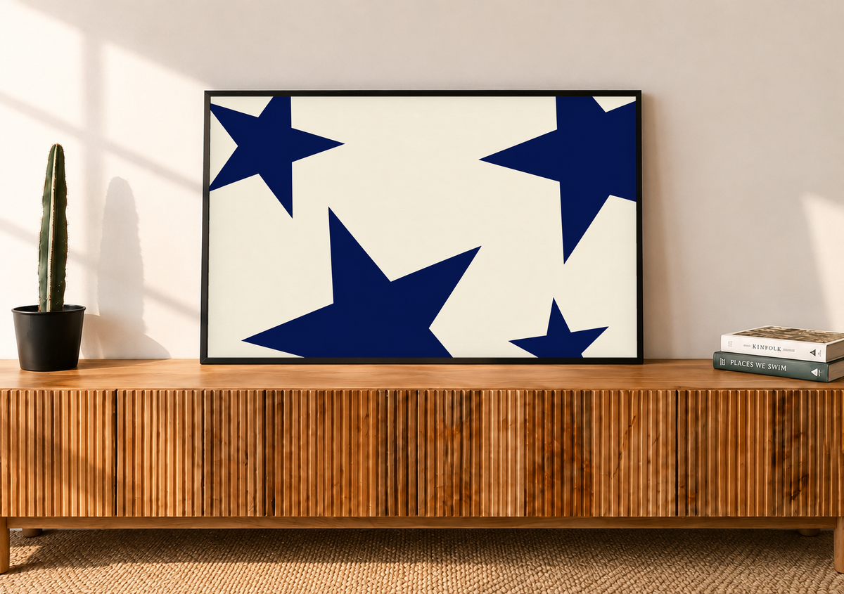 Horizontal navy star art print on cream, shown in a black frame