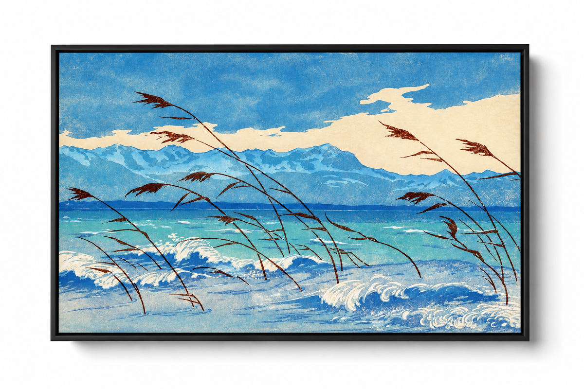 Russet reeds bend over curling blue and cream waves, with turquoise water, a distant mountain ridge and broad pale clouds behind. Dark floating canvas frame against a plain white background with a soft shadow.