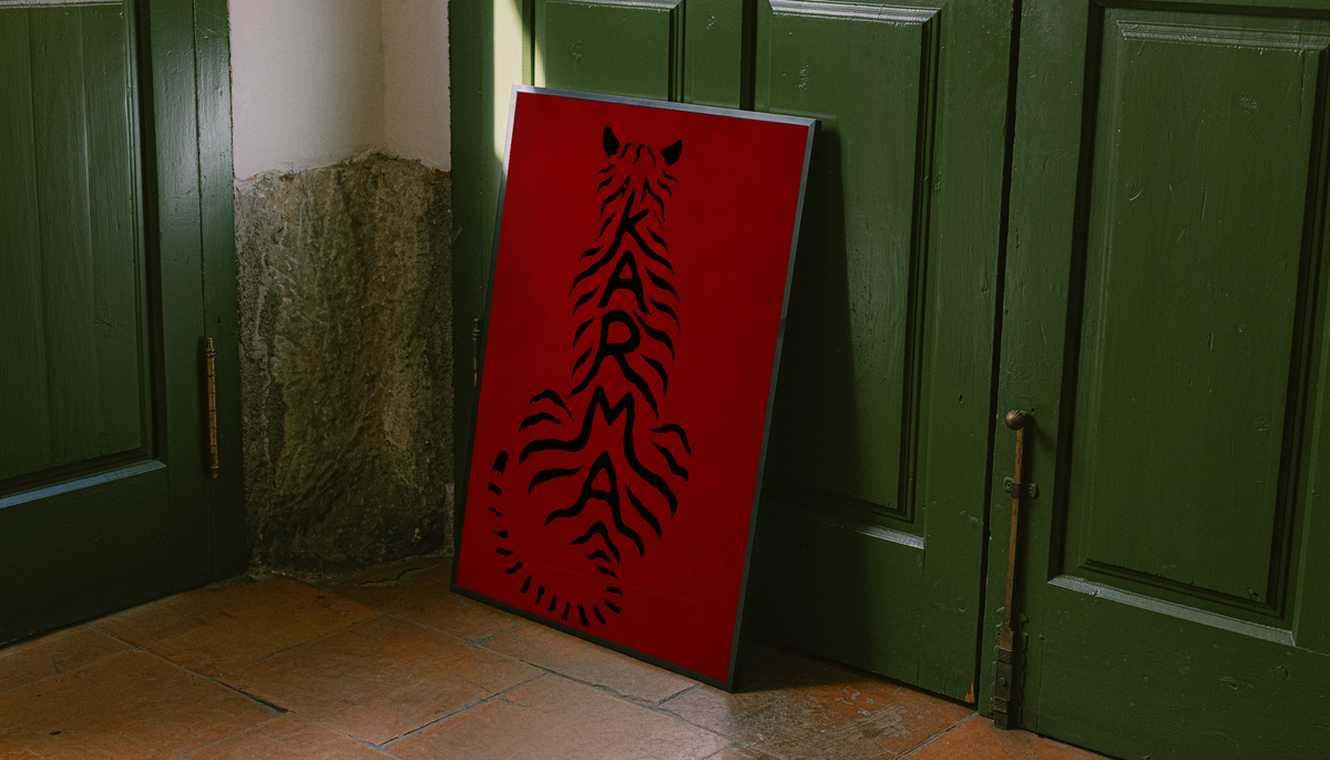 Unframed deep red poster with black feline typography, leaning against green doors.