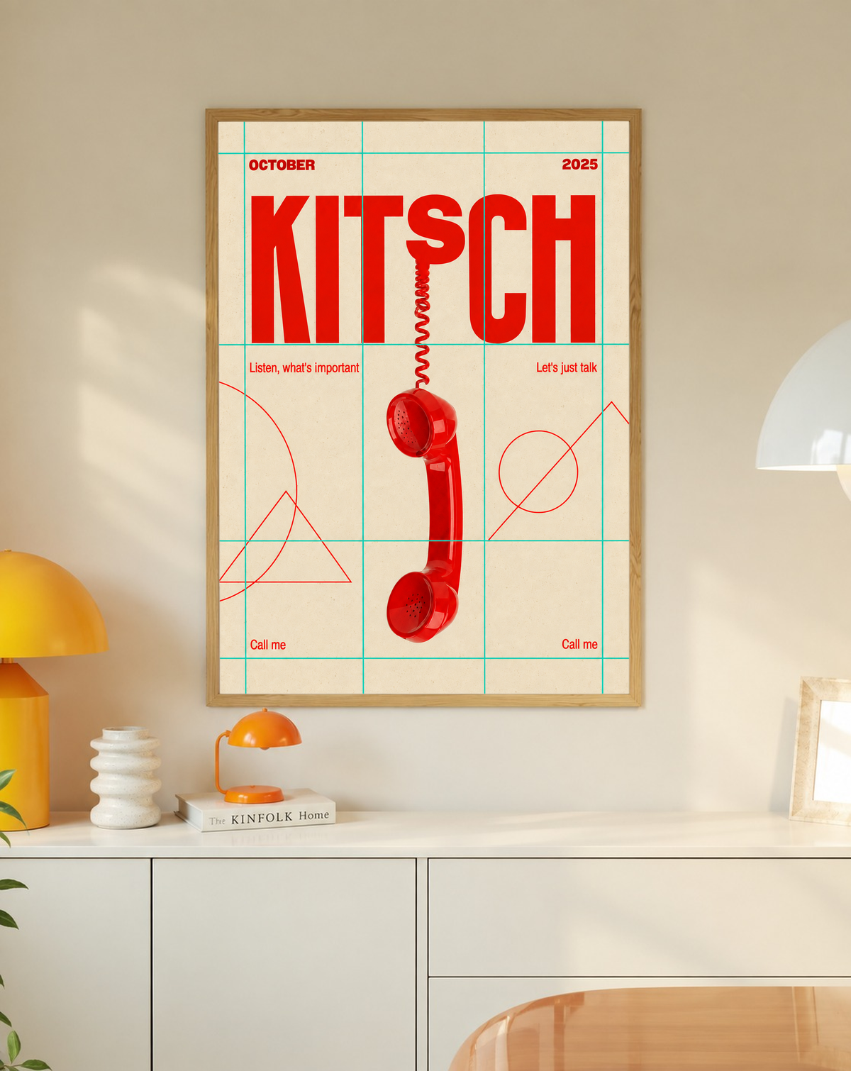 A red telephone receiver beneath Kitsch lettering on a mint grid and cream field in a slim oak frame on a cream wall above a white cabinet