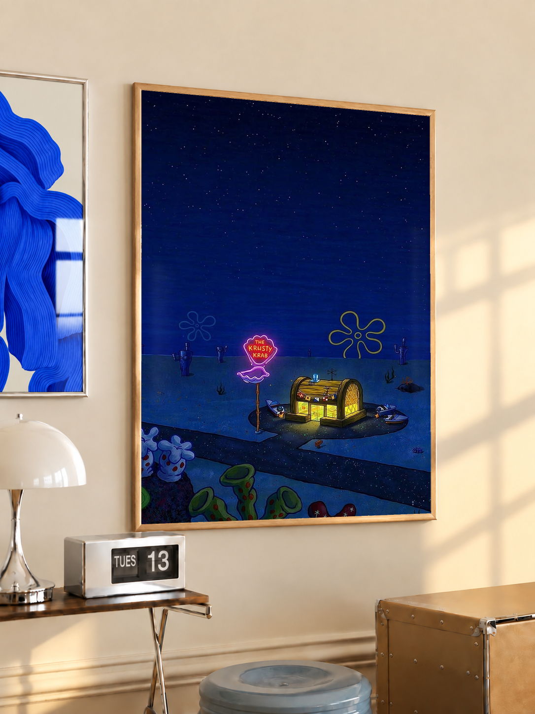 Krusty Krab nighttime scene in an oak frame on a warm cream wall above a small table and dome lamp