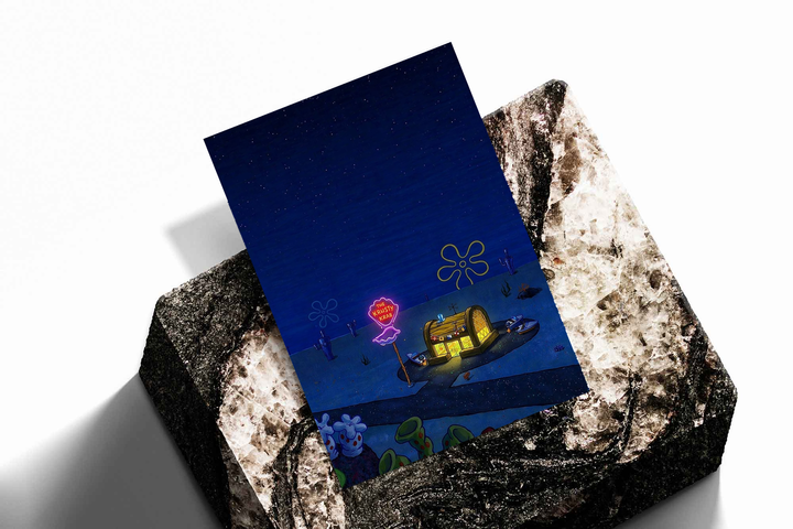 Krusty Krab nighttime scene as an unframed print propped against a pale wall on a rough stone