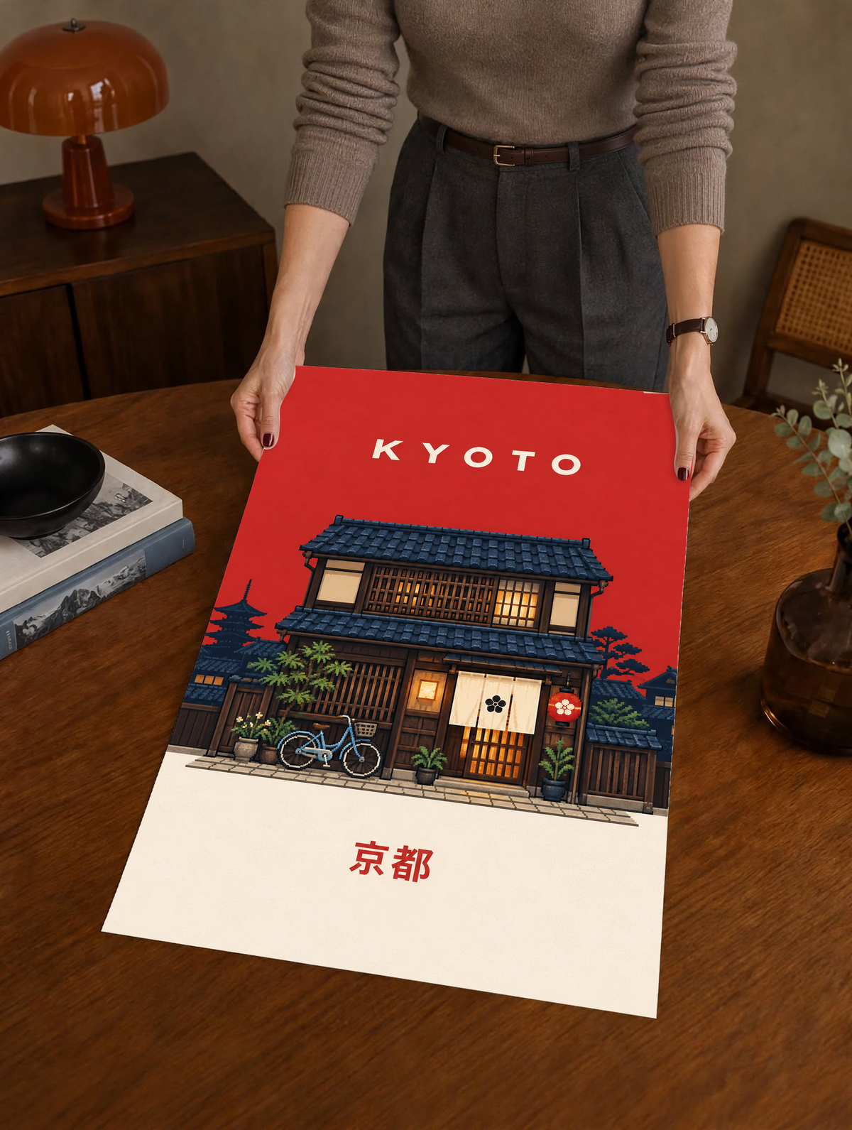 Red KYOTO poster with illustrated machiya house, bicycle, warm windows, and Japanese text.