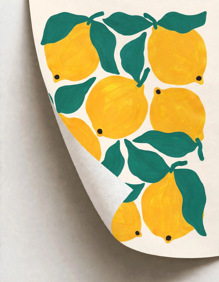 Rolled paper poster showing yellow lemons and green leaves on a cream sheet
